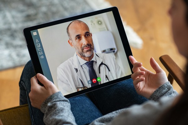 Video chat with a doctor through a tablet.