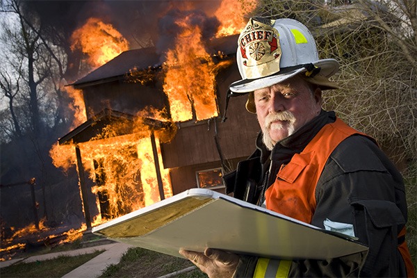Fire chief supervises a burning house